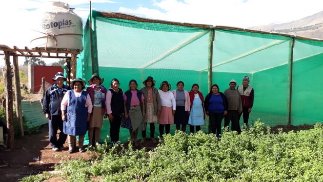 Women farmers from the community of Huasao, in the Andean highlands region of Cuzco, Peru, stand in front of one of the 50-sq-m solar tents, which has a 750-litre water tank for the drip irrigation module for their vegetables. Credit: Mariela Jara/IPS